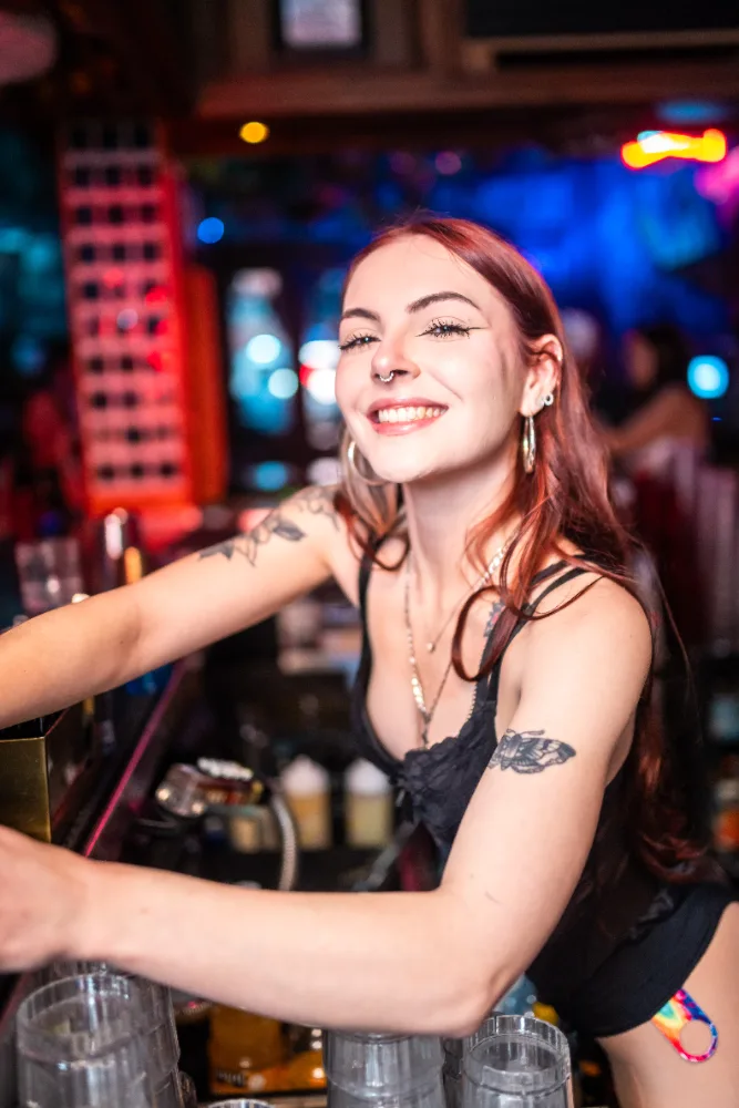 Bartender pouring drinks behind the bar at Mother Tucker's Tavern in Old Town Scottsdale