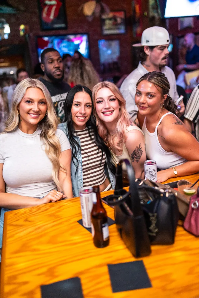 Friends hanging out at a table inside Mother Tucker's Tavern in Old Town Scottsdale