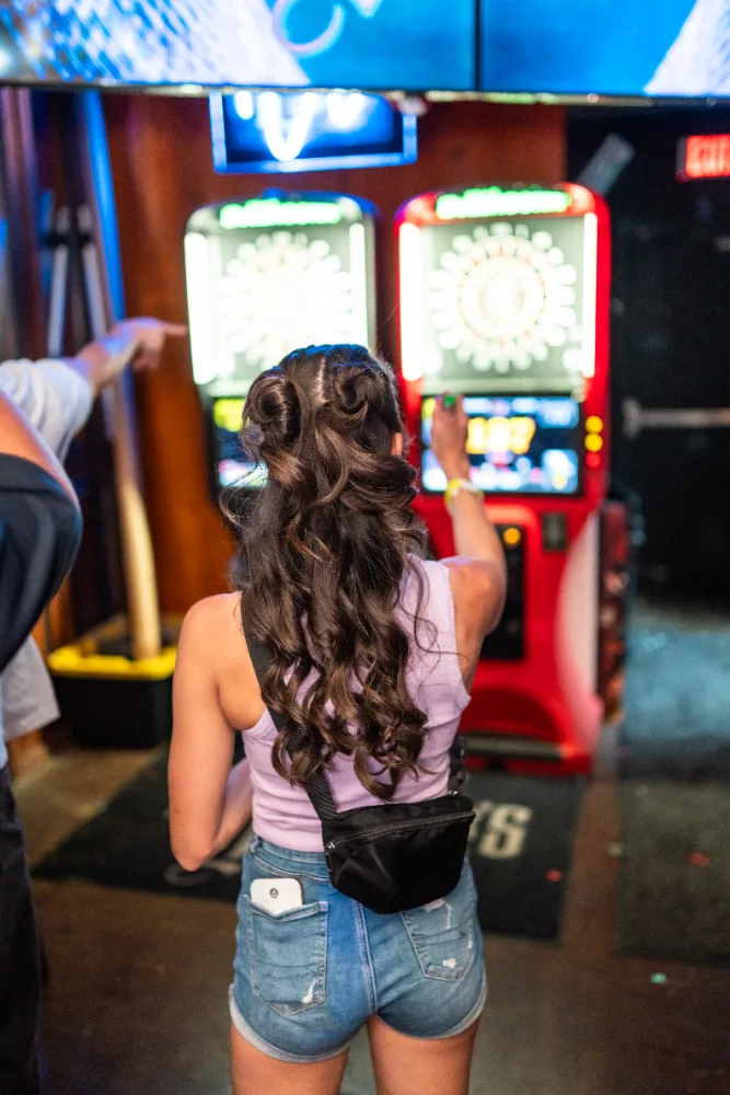 Guest playing electronic darts at Mother Tucker's Tavern
