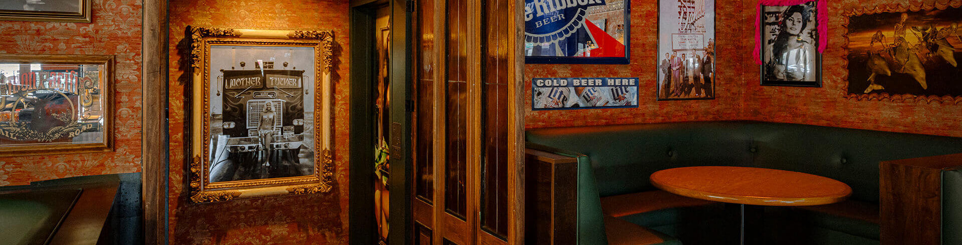 Interior shot showing hallway and wooden booth seating inside the tavern
