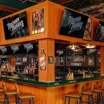 Corner view of the main bar counter and TVs at Mother Tuckers Tavern